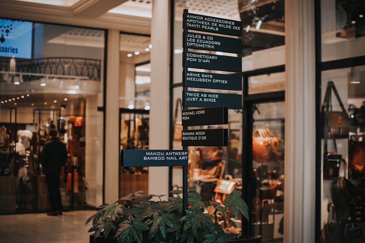 Signboard located near store with various goods