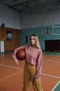 Woman in Pink Long Sleeve Shirt Holding Basketball