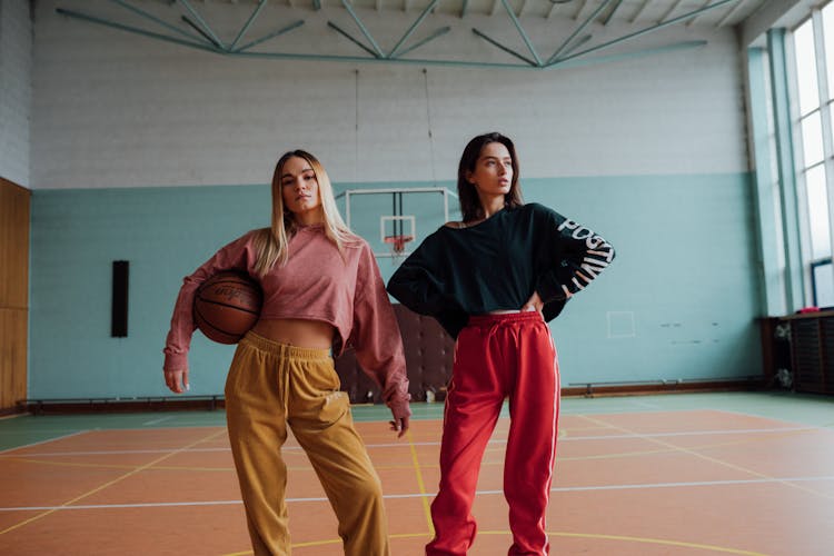 Women Holding A Basketball Posing