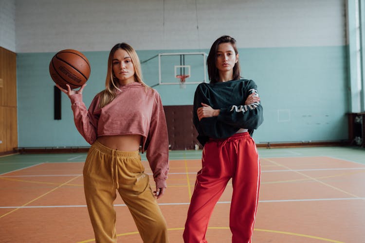 Women Standing In The Middle Of A Basketball Court