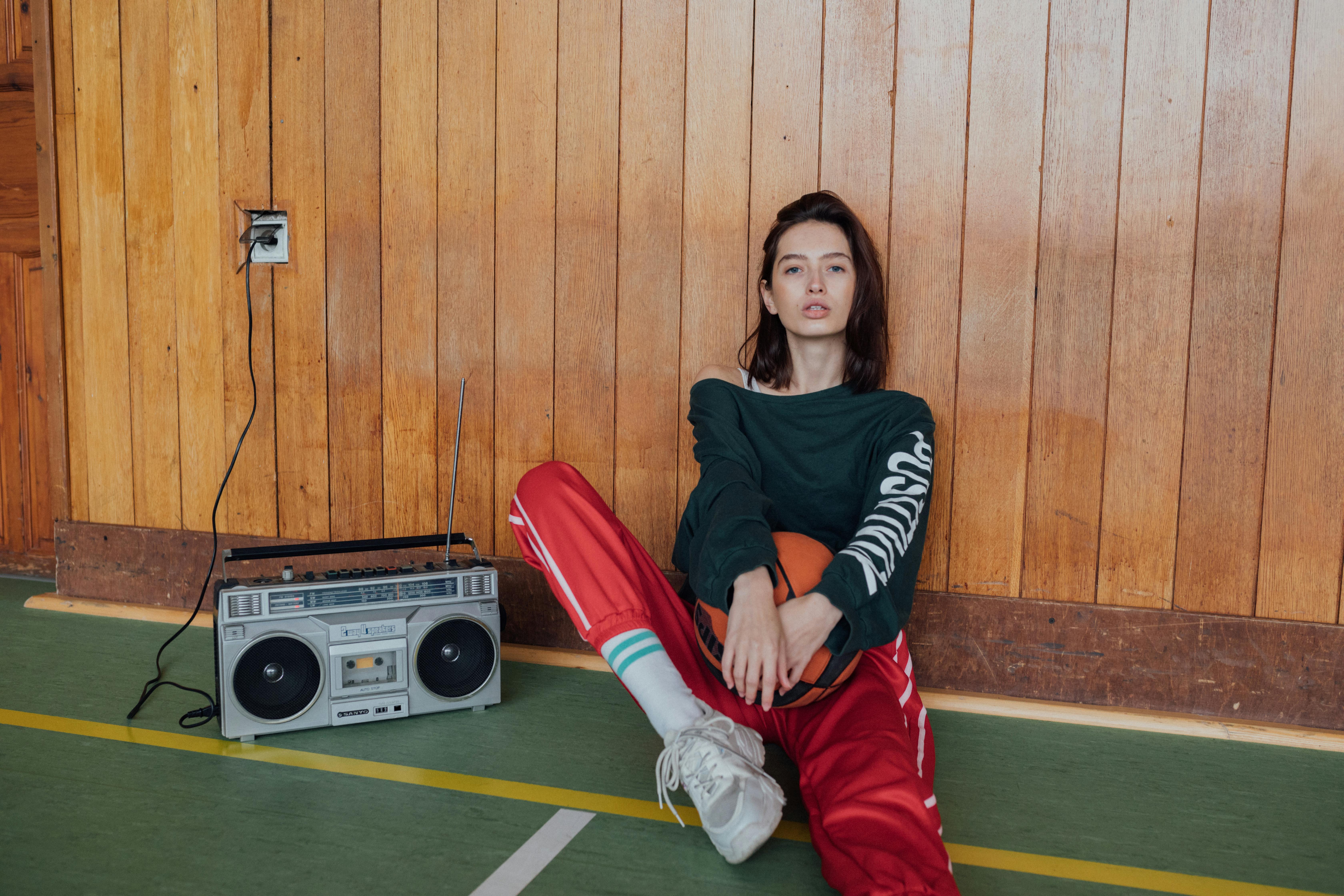 woman holding a ball sitting on the floor