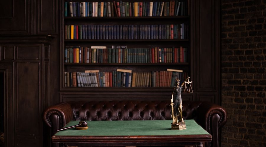 A study with shelves of law books and a desk