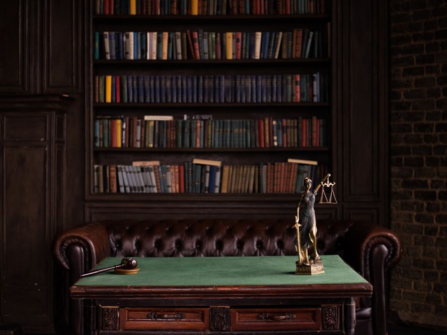 A study with shelves of law books and a desk