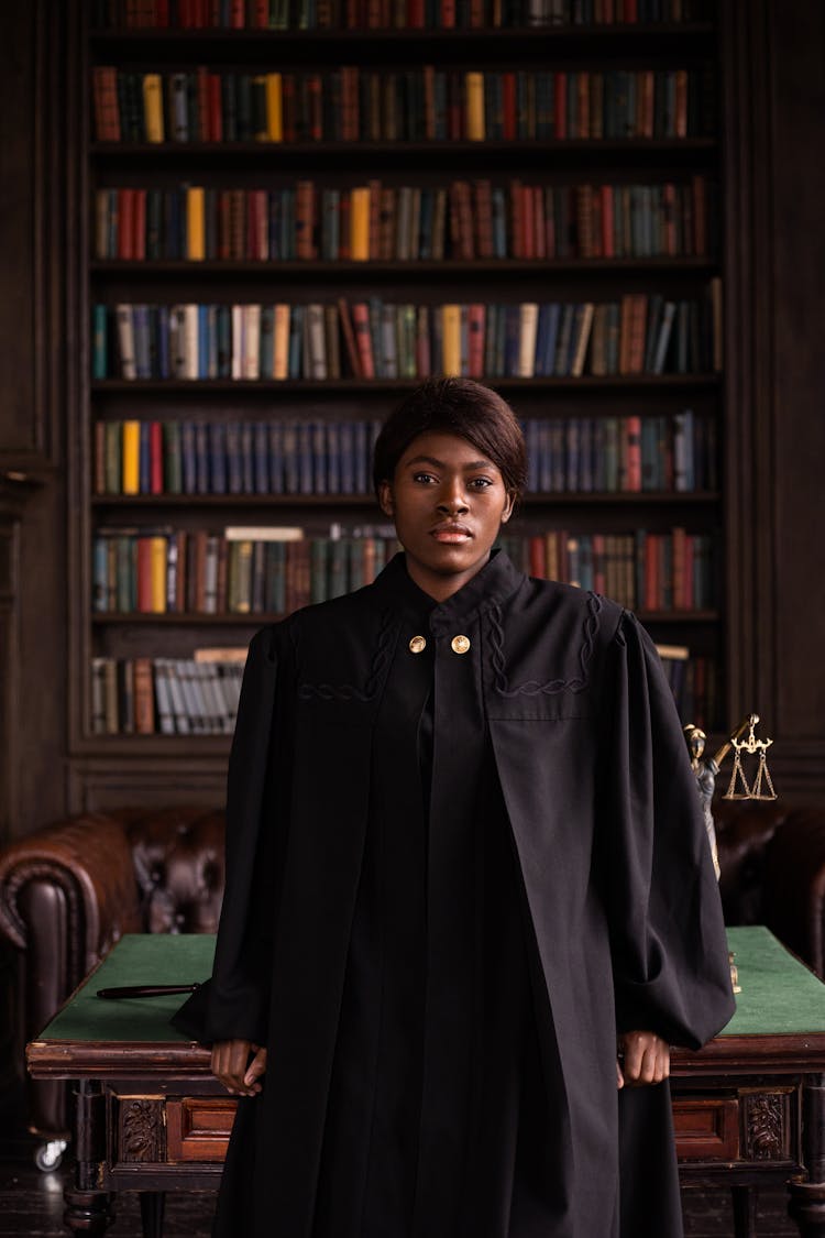 Woman University Tutor In Black Traditional Outfit In Library