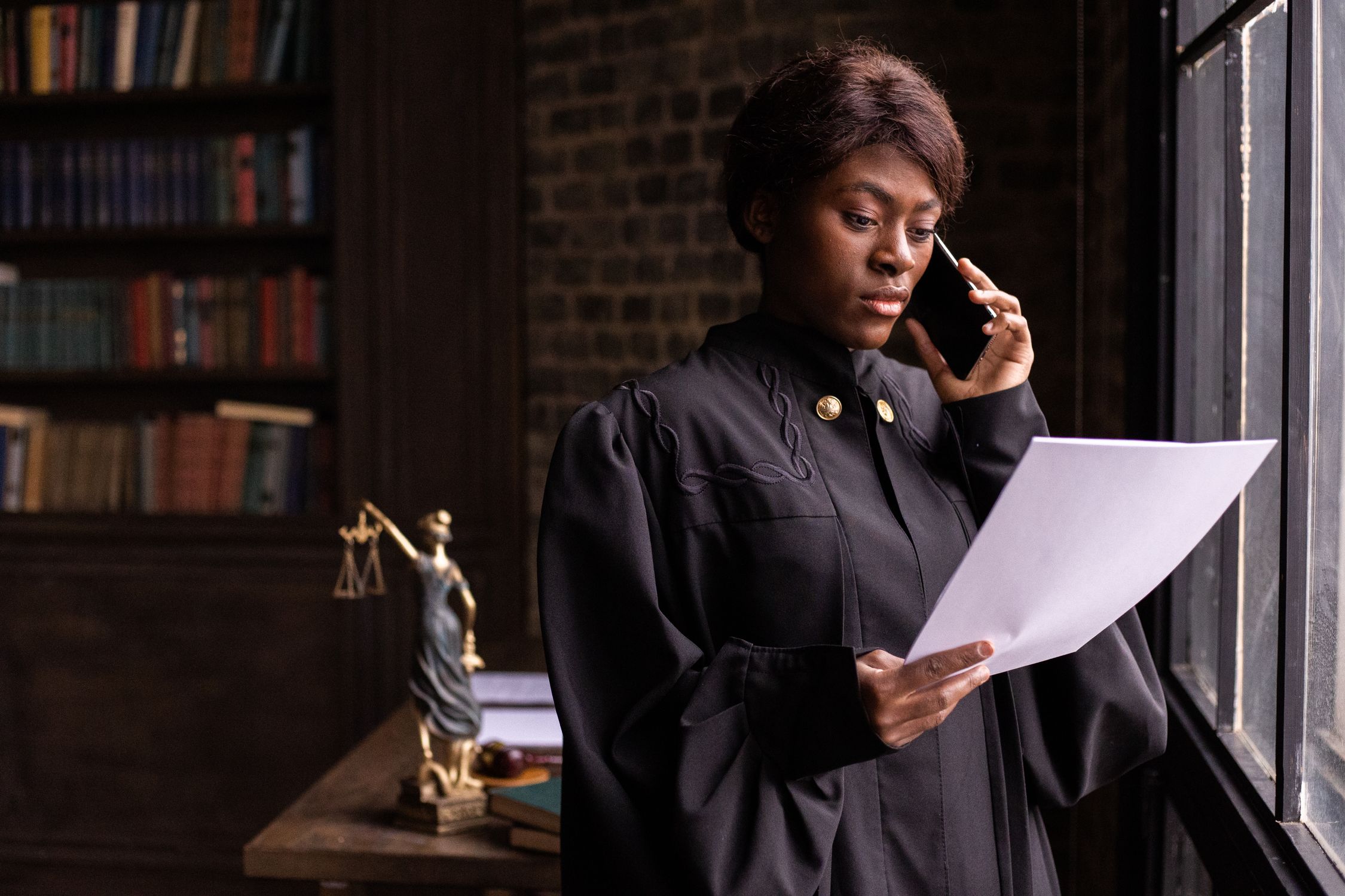 A Judge Reading a Document while Having a Phone Call · Free Stock Photo