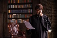 Man in Black Coat Reading Book