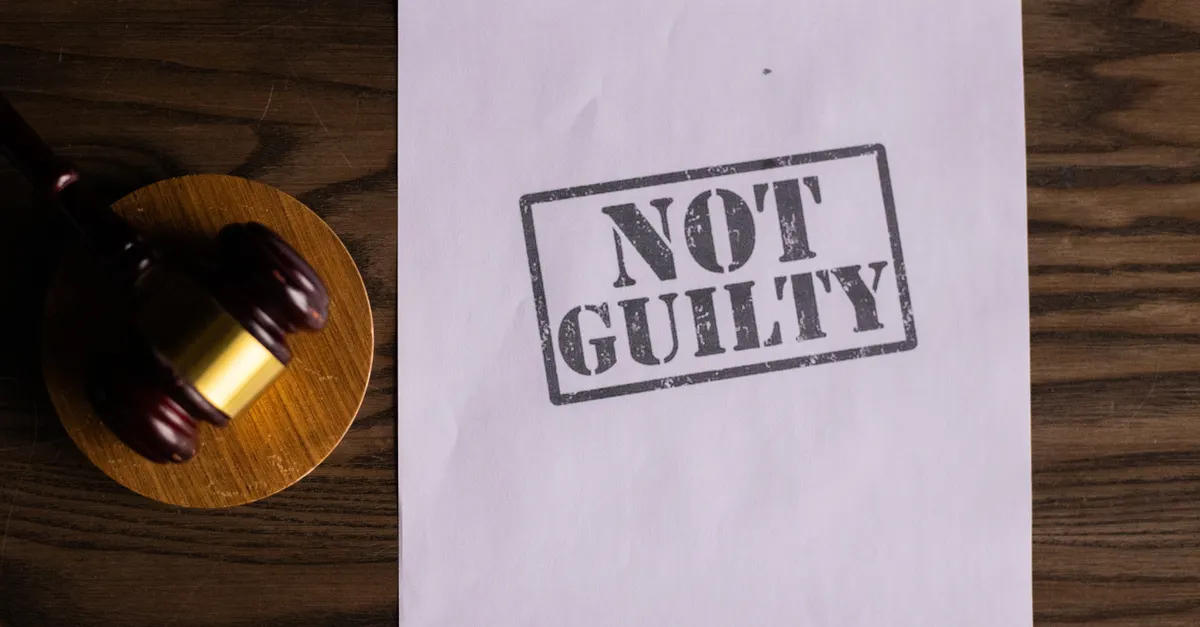 A court document beside a wooden gavel on a desk