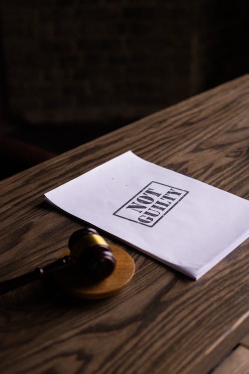 Free White Printer Paper on Brown Wooden Table Stock Photo