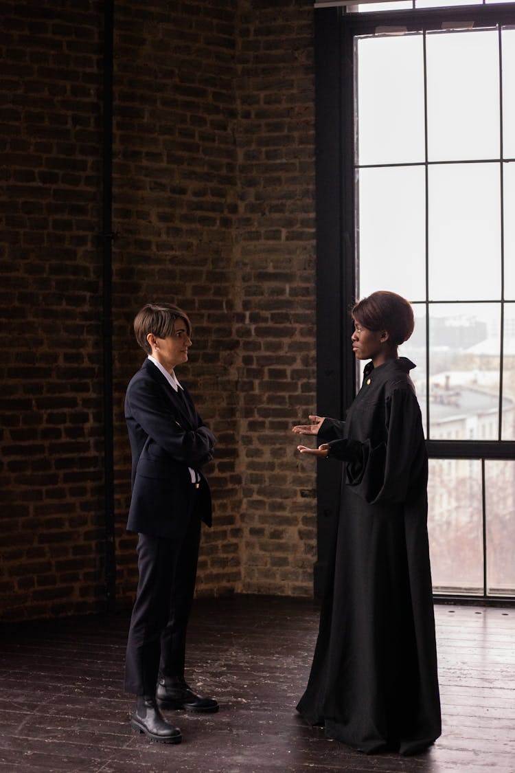 A Woman In A Suit Talking To A Judge