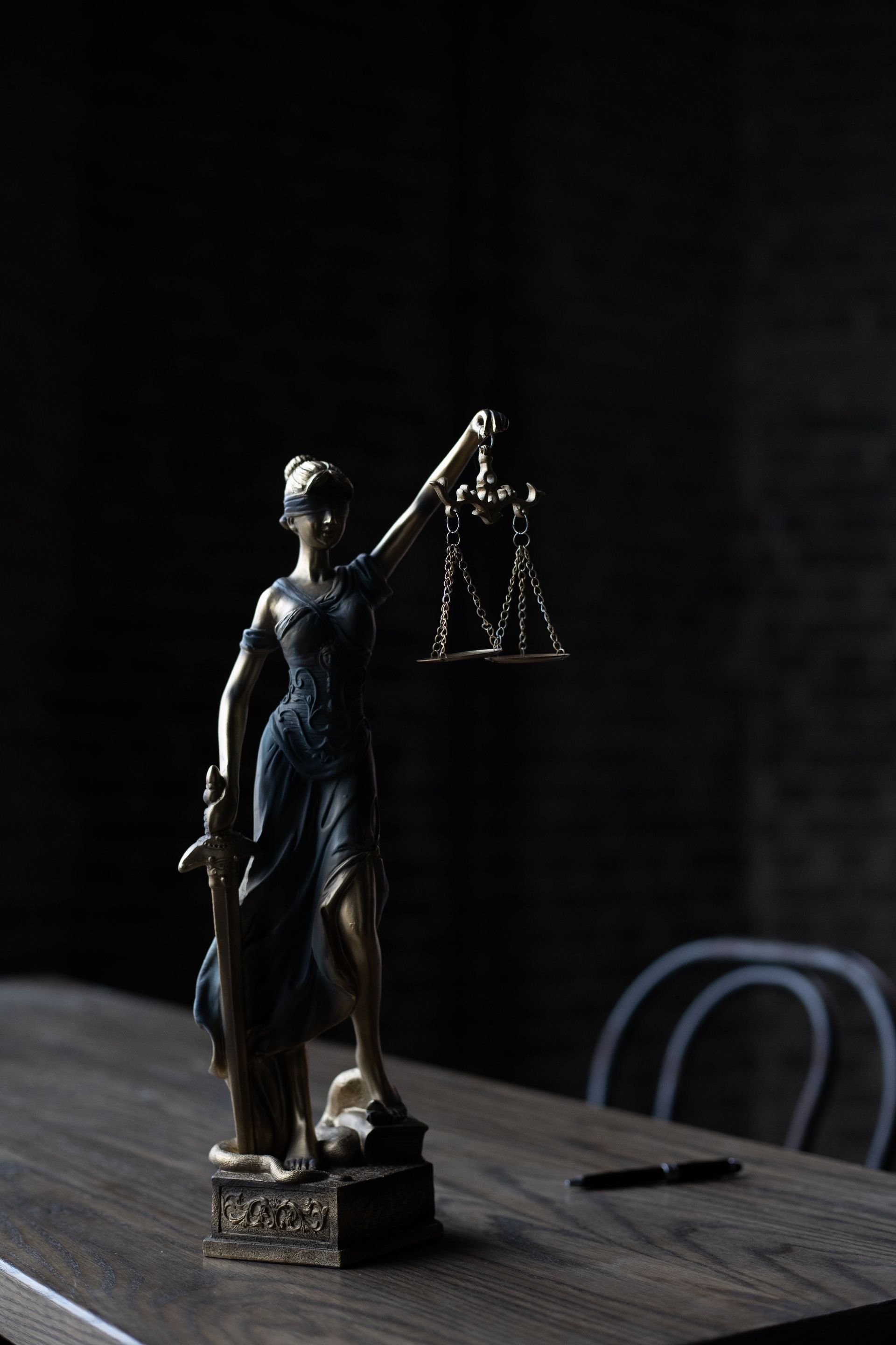Dramatic lighting on Lady Justice figurine