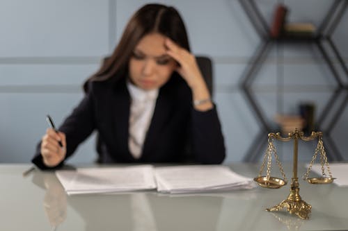 Free An Exhausted Lawyer Reading the Case Paper Stock Photo