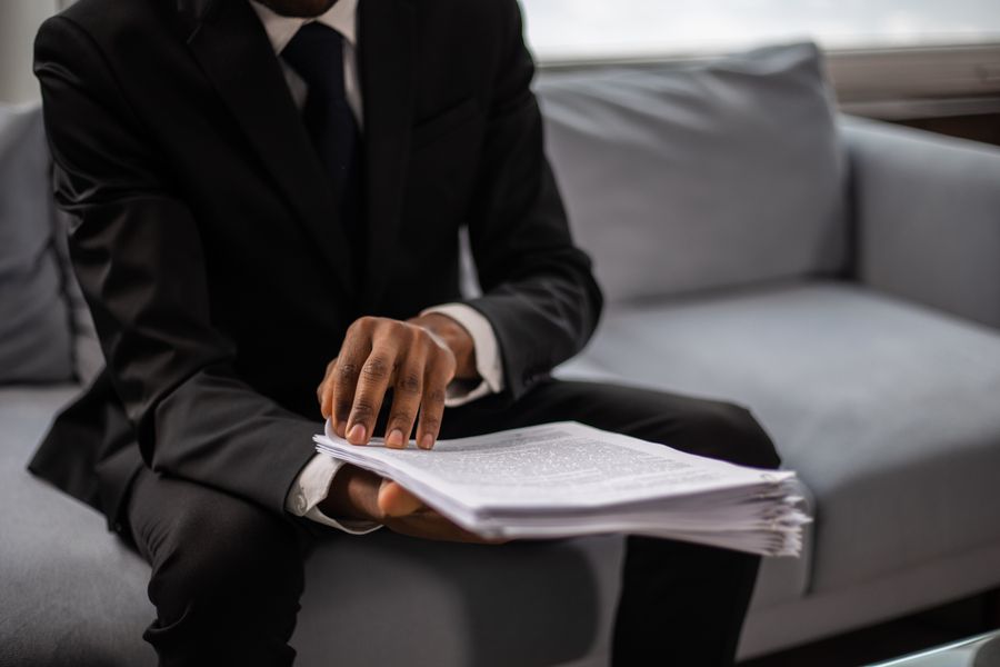 African businessman in a one-on-one coaching conversation reviewing documents