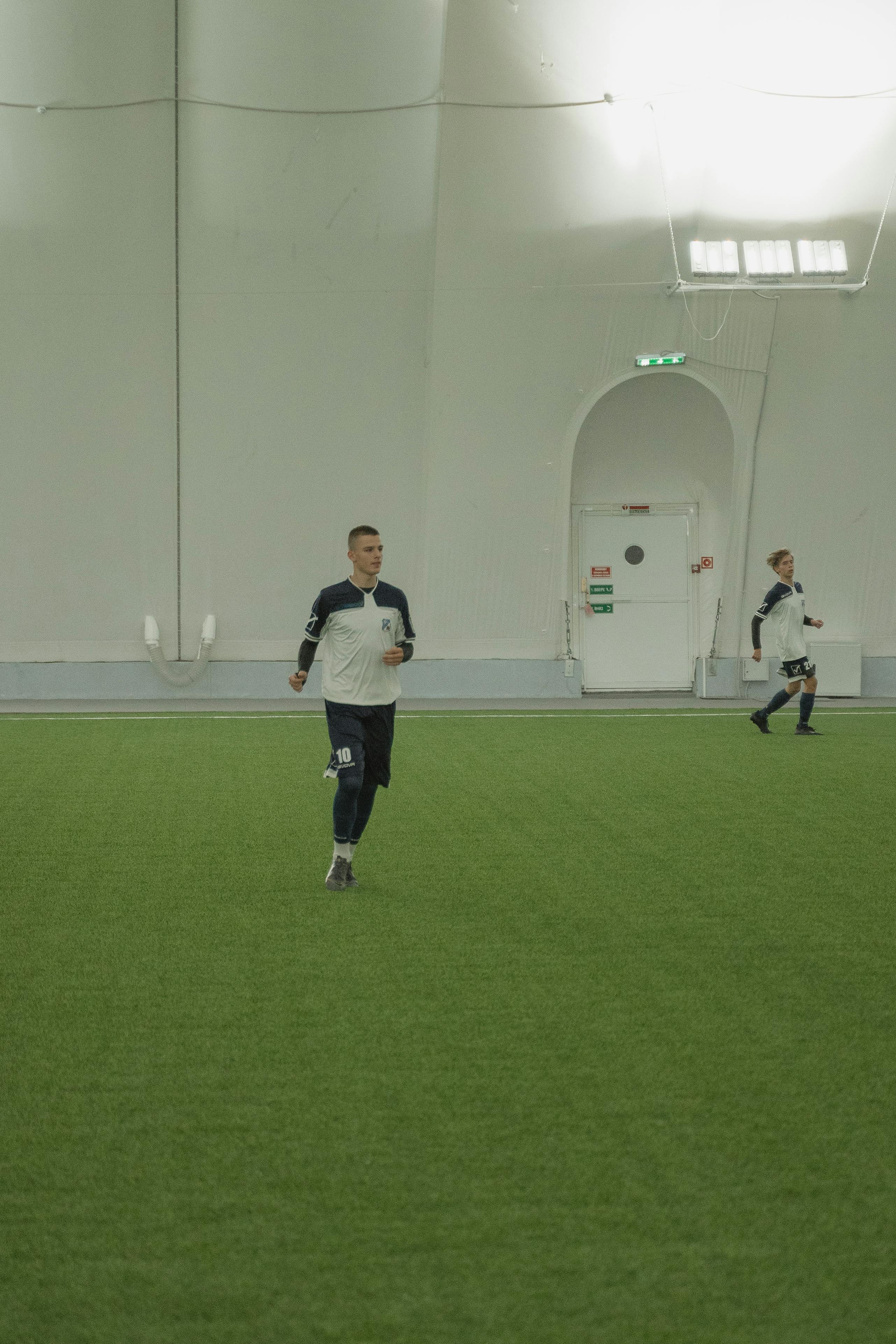 men running on a soccer field