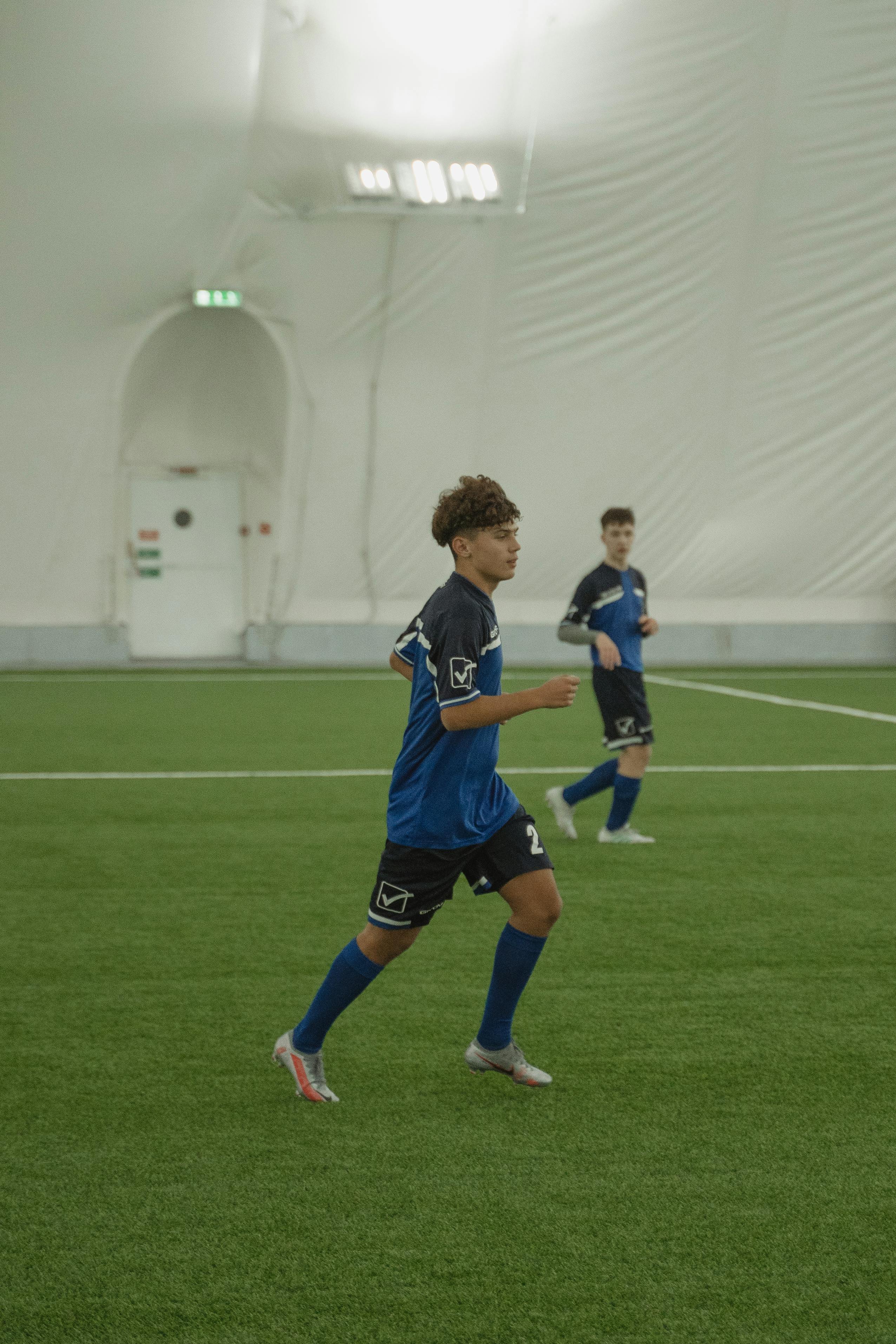 men running on a soccer field