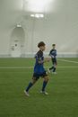 Boy in Blue and White Soccer Jersey Shirt and Black Shorts Standing on Green Grass Field