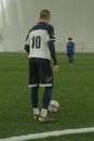 Man in Black and White Jersey Shirt and Black Shorts Standing on Green Grass Field