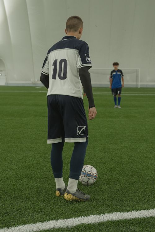 Free Soccer player in number 10 jersey prepares to take a free kick on an indoor field. Stock Photo