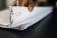 A Close-Up Shot of a Person Going Through Documents