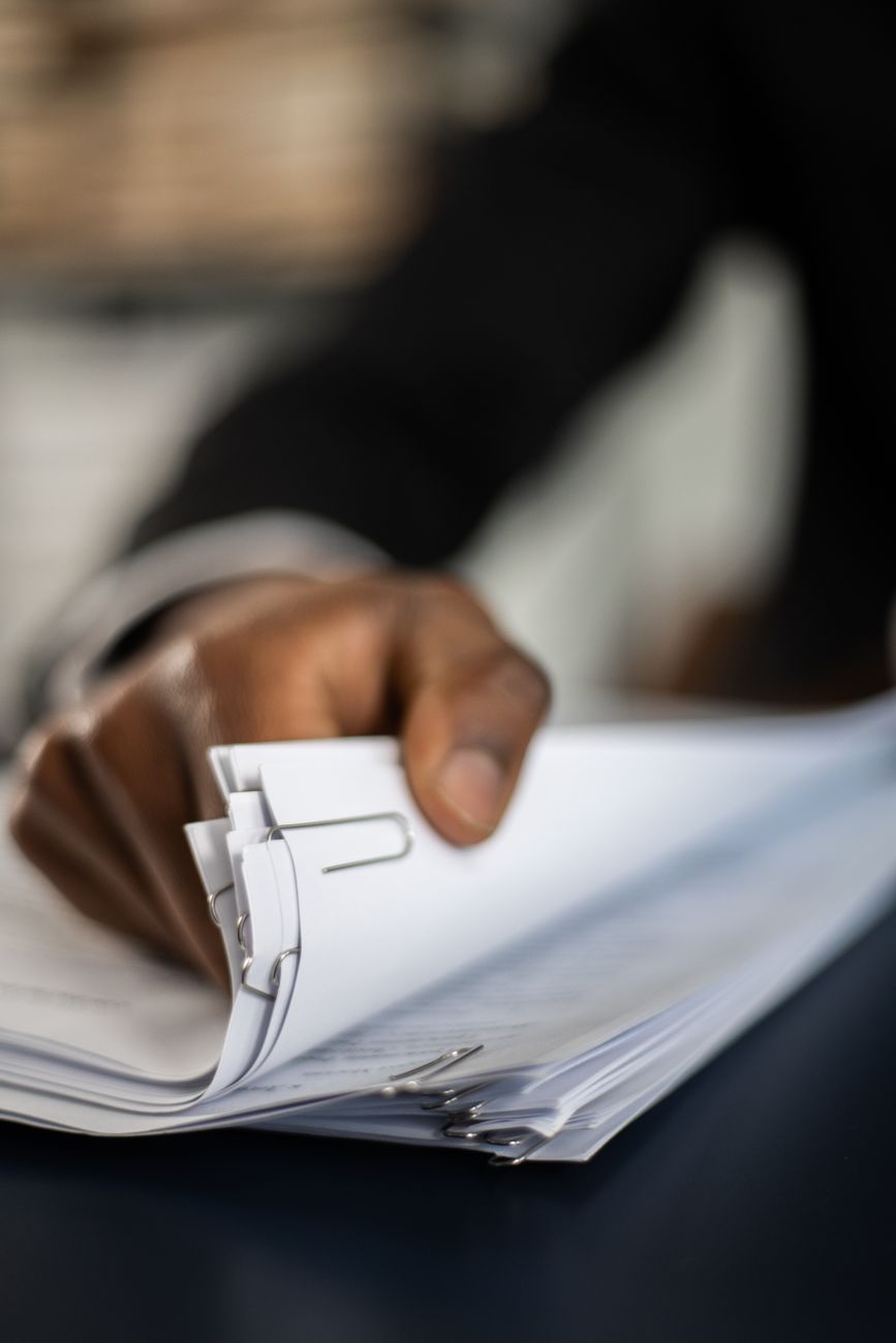 Stack of contract pages and legal documents on a desk