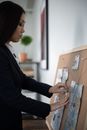 Woman in Black Blazer Holding Brown Wooden Board