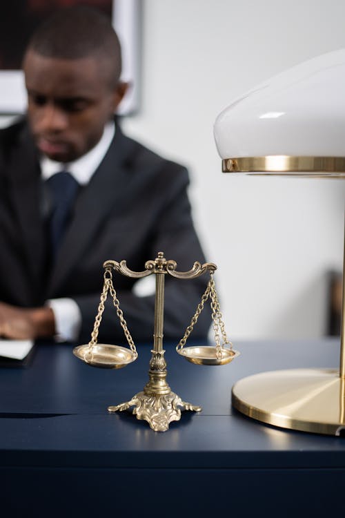 Free  Brass Colored Balance Scale on a Lawyer's Table Stock Photo