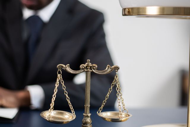 Lawyer at a desk with scales of justice