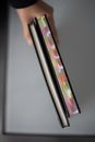 Person Holding Black and Pink Stick