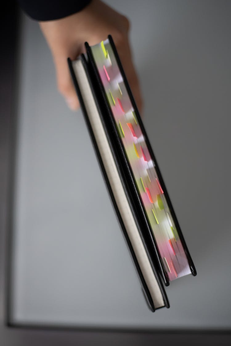 A Close-Up Shot Of A Person Holding Books