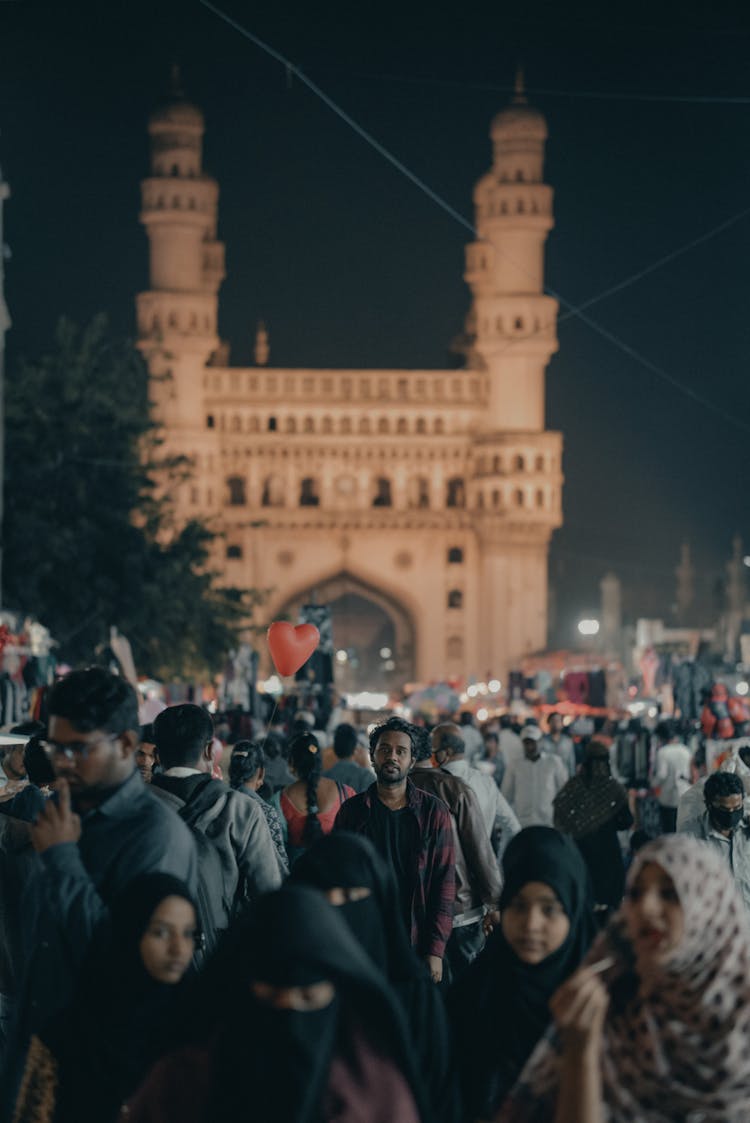 Indian People On City Street Against Old Monument