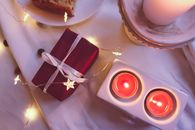 A Gift beside Lighted Candles