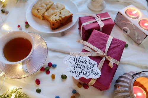 Gifts beside a Cup of Tea and Bread