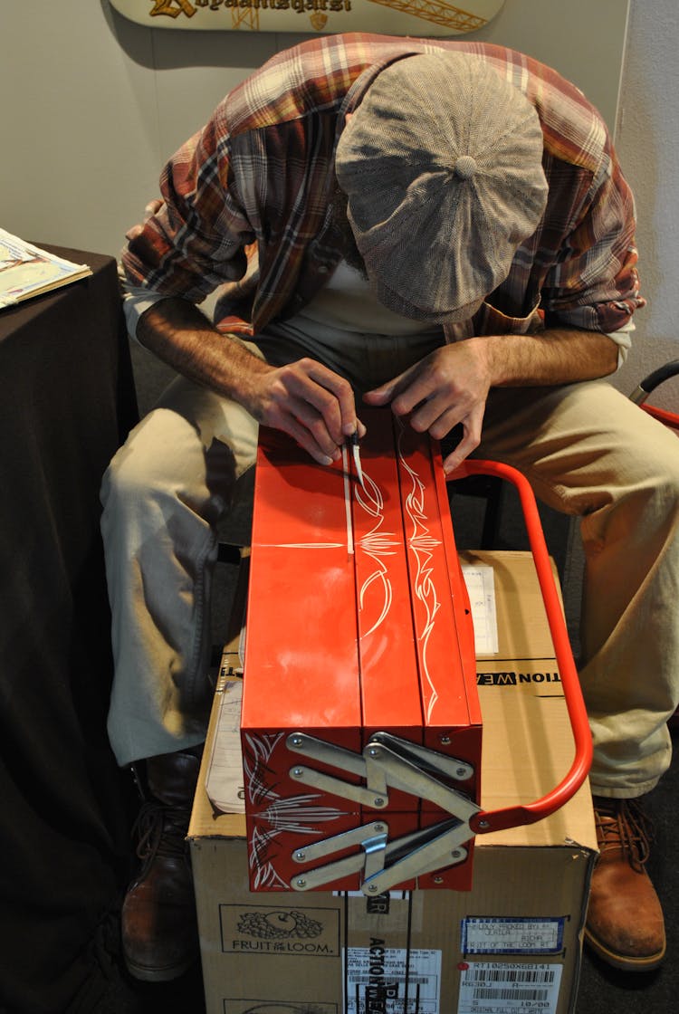 Man Hand Painting A Box 