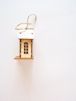 Detailed minimalist wooden house ornament with ample copy space ideal for Christmas themes.