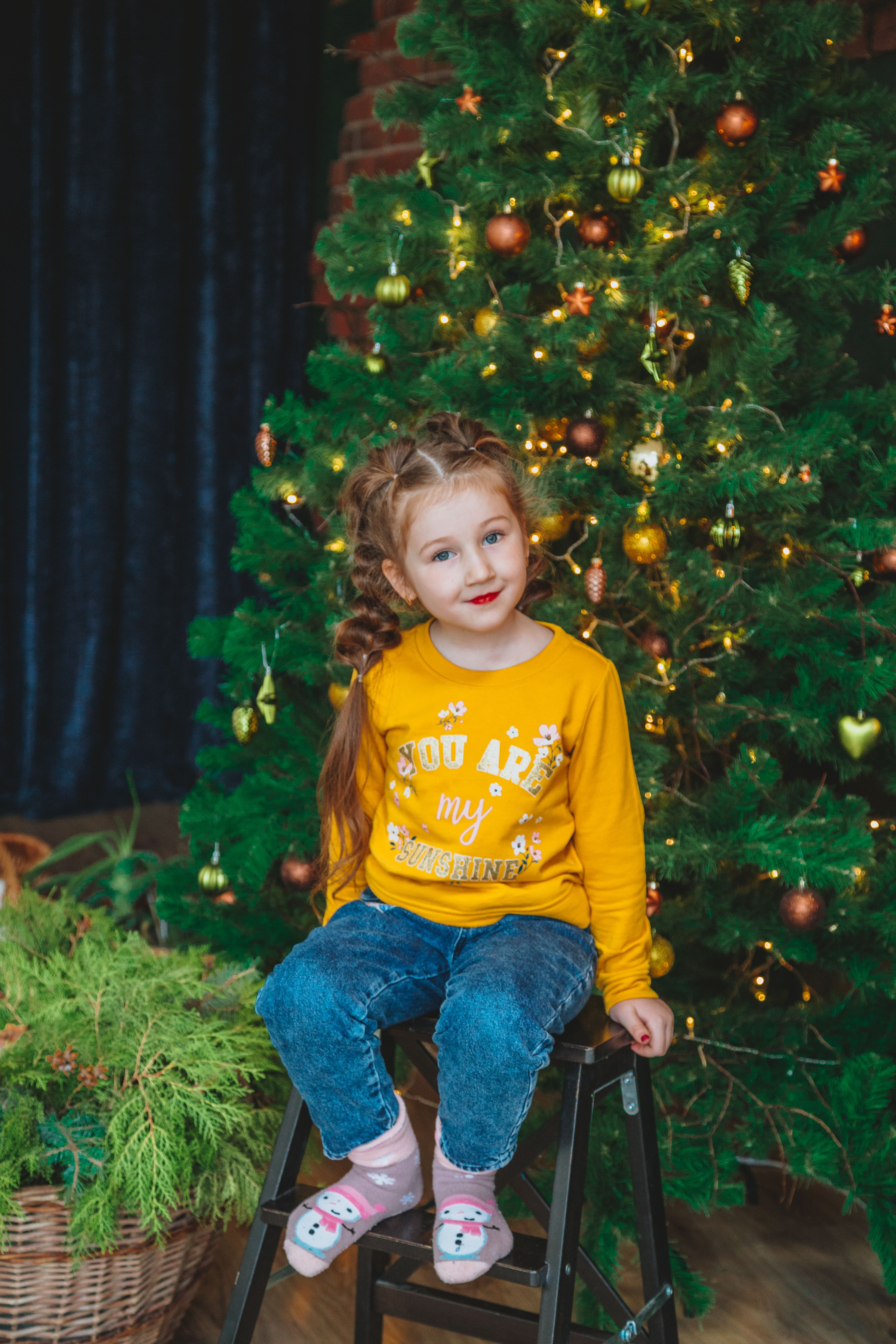 Happy little girl sitting on chair · Free Stock Photo