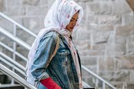 Muslim woman descending stairs to subway