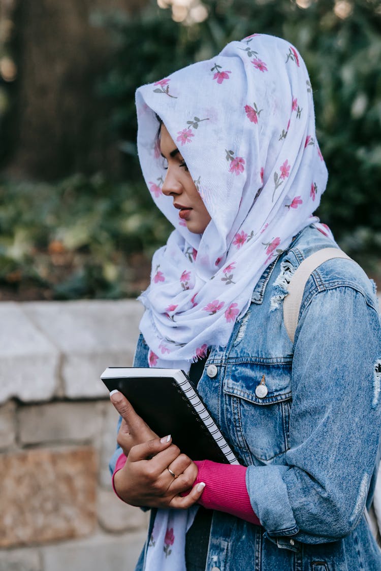 Pensive Muslim Student With Notebook In Park