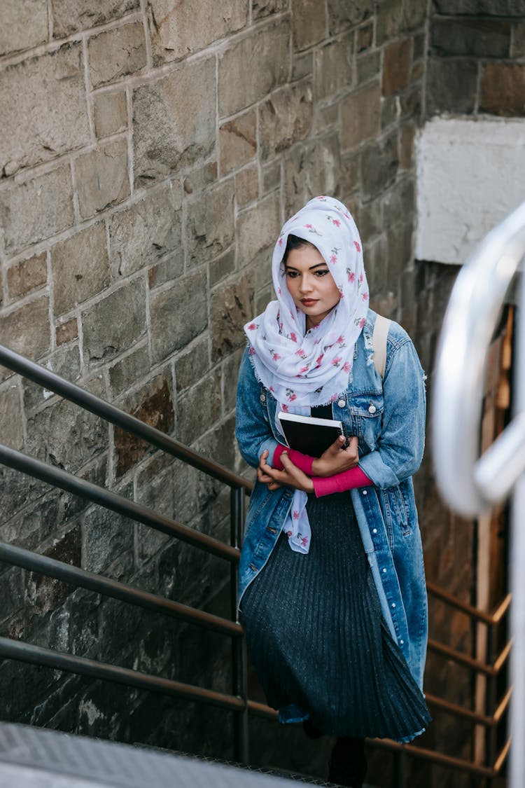 Young Muslim Woman Ascending Staircase