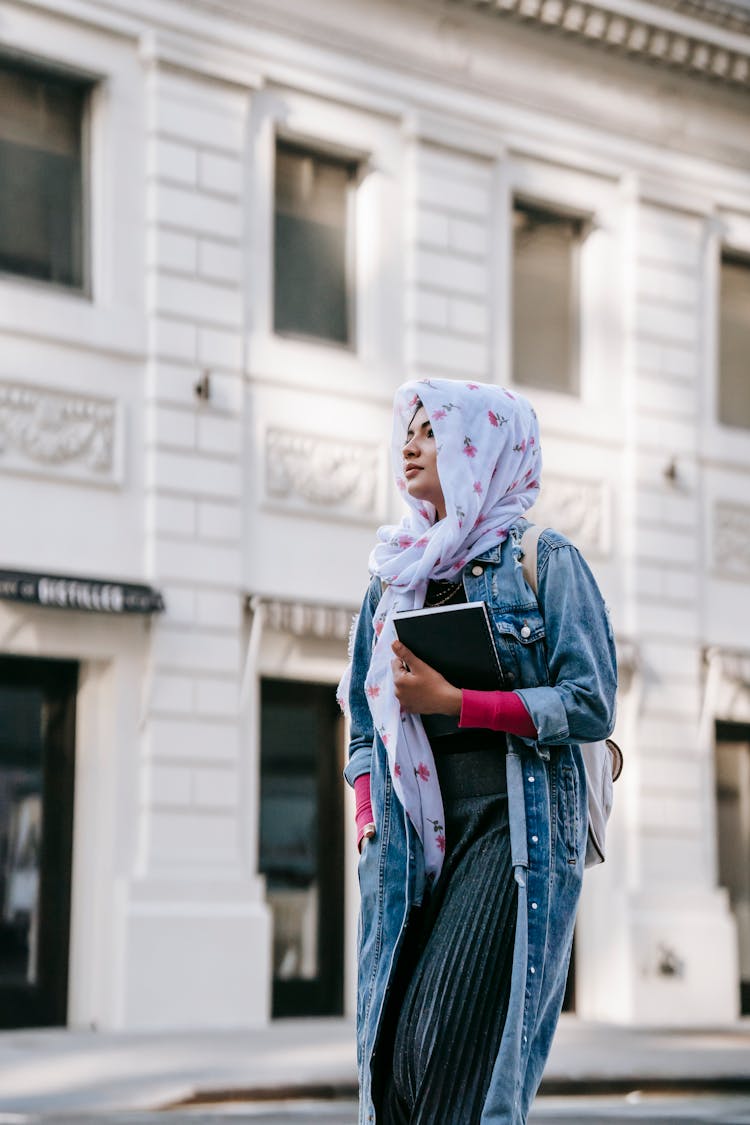 Ethnic Woman Walking Along Street