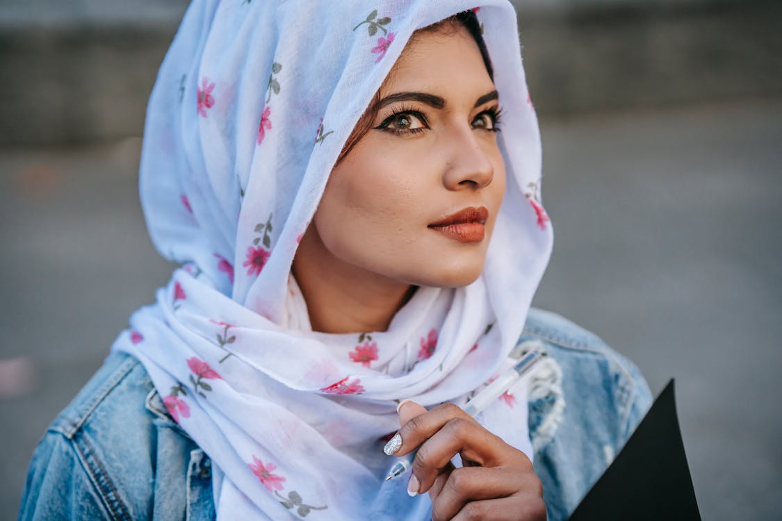 Free Dreamy Muslim woman thoughtfully looking away Stock Photo