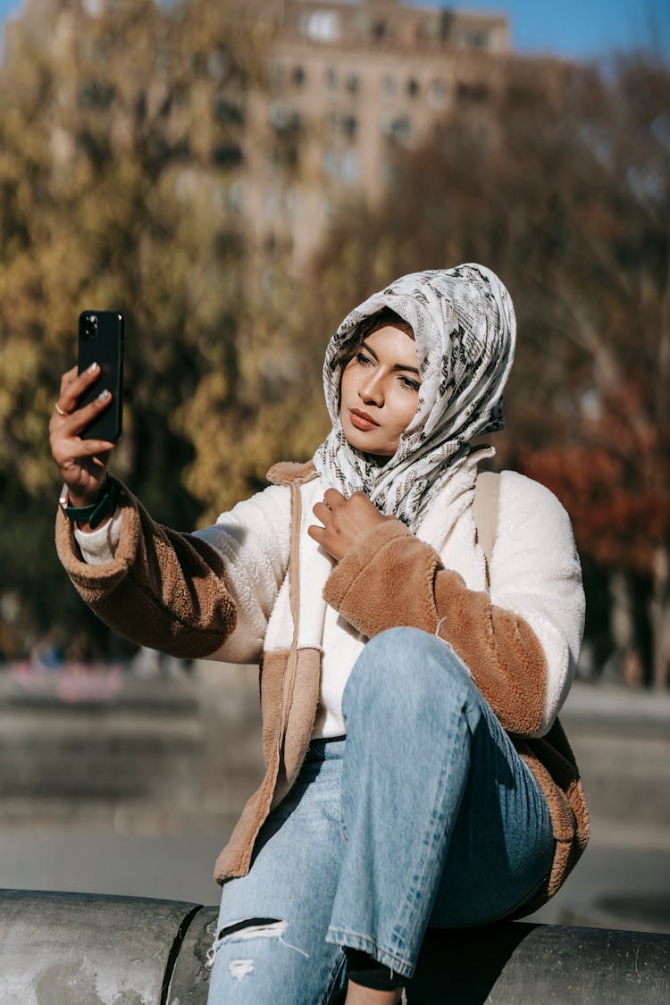 Trendy Young Muslim Lady Taking Selfie In City Park