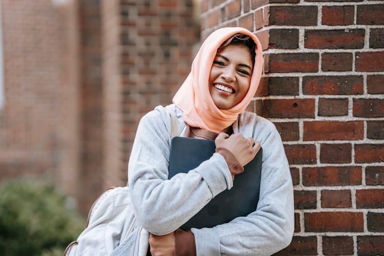 Happy Woman With Laptop On Street