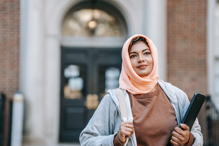 Cheerful Young Muslim Woman With Laptop On Street