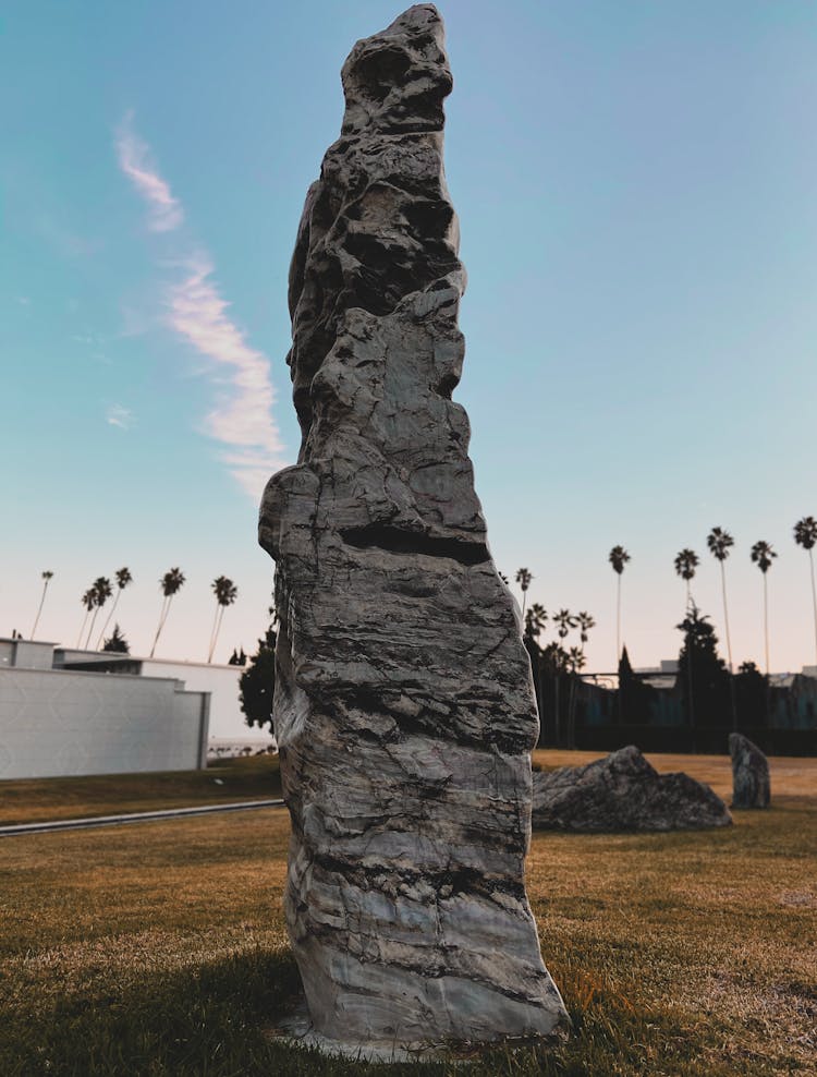 Black Rock Formation On Green Grass