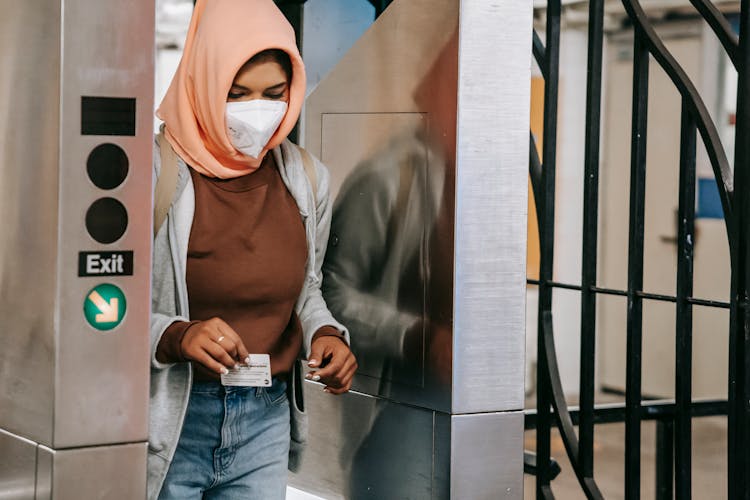 Muslim Lady In Mask Going Through Metro Gate