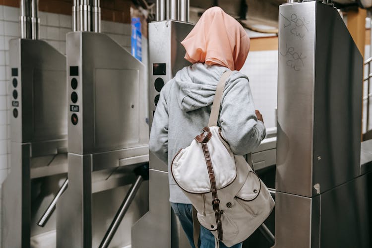 Anonymous Female Near Turnstile In Subway