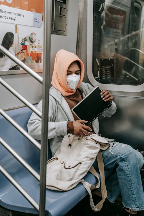 Mulher De Hijab Branco E Jaqueta Jeans Azul Segurando Um Computador Tablet Preto