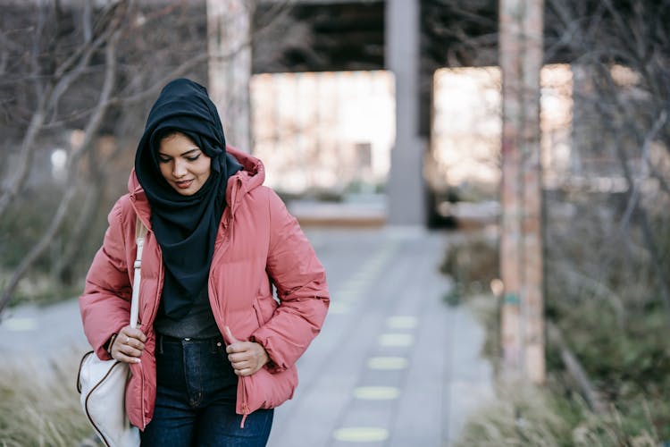 Ethnic Woman Walking On Road In Street