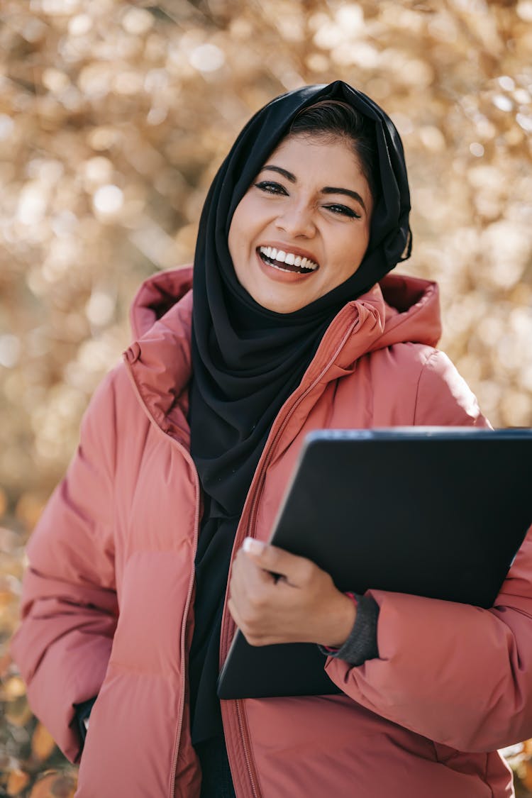 Smiling Middle East Woman With Laptop In Park