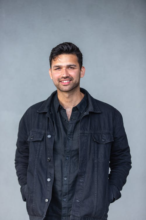 A Man in Black Long Sleeves Smiling