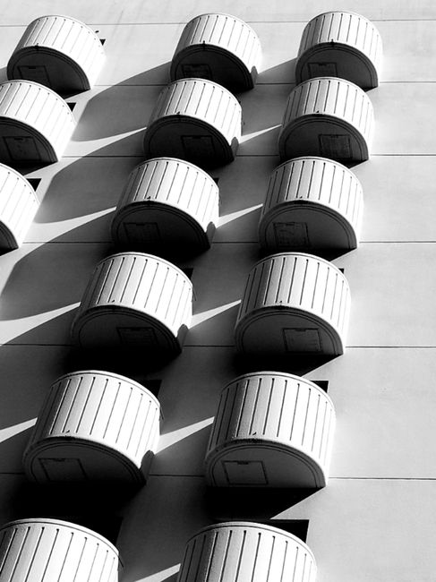 Black and white of facade of construction with plenty of half round balconies